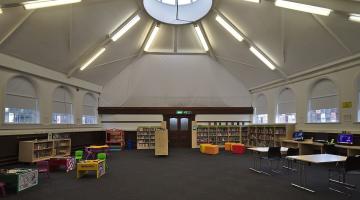 Bookshelves and reading tables inside a public library