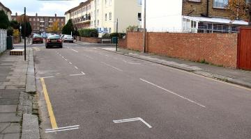A residential street with marked parking bays